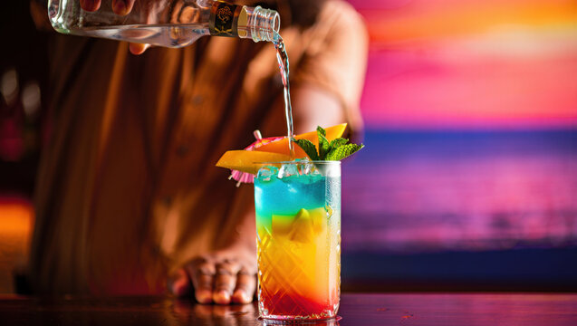 Pouring Clear Spirit Into A Layered Gradient Concoction