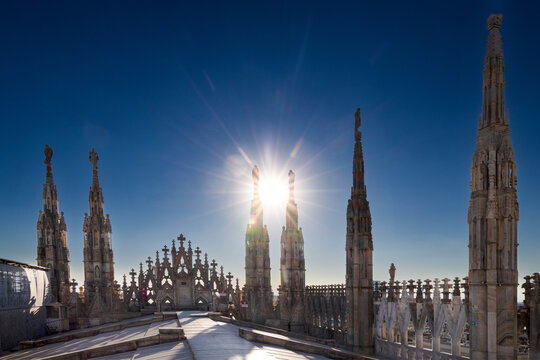 The Milan cathedral rooftop features the largest walkable Gothic roof in the world and the iconic gold Madonnina statue