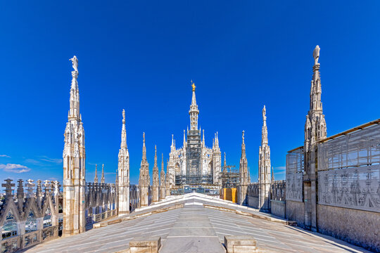 Duomo di Milano rooftop features the largest walkable Gothic roof in the world, offering unparalleled views of Milan and the iconic gold Madonna statue