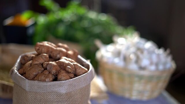 Close up of dried ginger and garlic displayed in rustic kitchen baskets