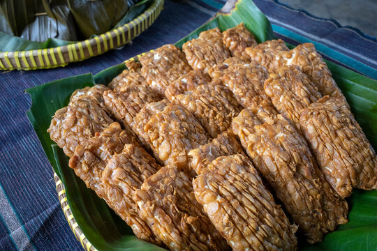 Close up of Tempe Garit Goreng (fried soybean cake) on banana leaf. Indonesian traditional food