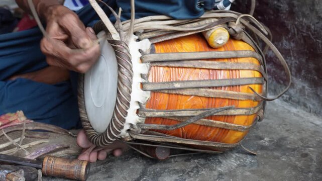 Traditional Hand Drum Repair with Rope Tensioning by Skilled Artisan