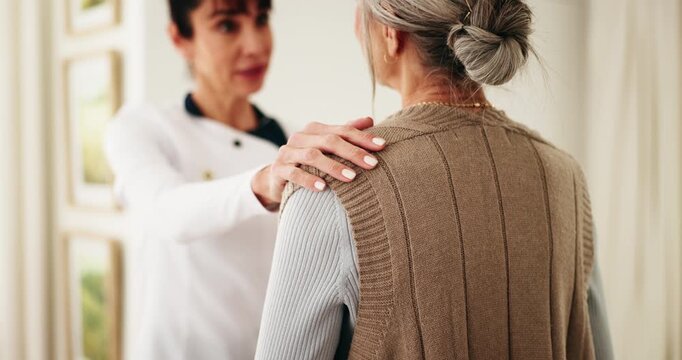 Healthcare, old woman and caregiver support in home with health checkup, follow up care or service. Hand on shoulder, senior patient or carer in homecare for medical advice, encourage healing or help