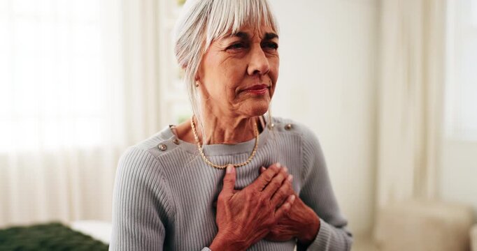 Senior, woman or bed with heart attack in home for cardiac arrest, cramp or chest pain. Elderly, female person or sore ache with virus, disease or chronic stress for pneumonia or illness in house