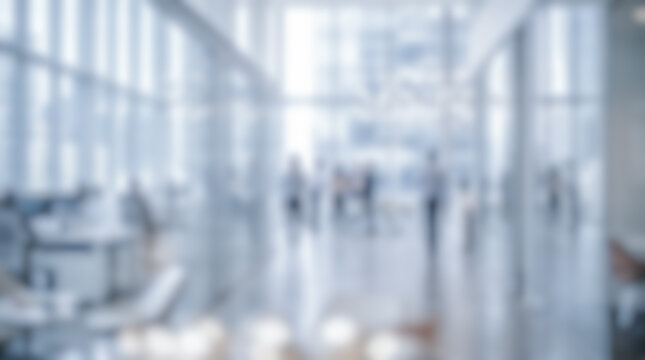 Bright modern blurred office interior background showing professional business people walking corporate workplace setting abstract contemporary room soft natural daylight bokeh