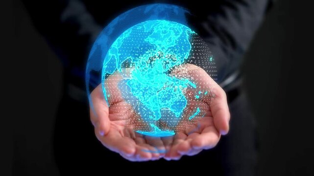 A person holding a glowing blue digital earth globe hologram in their hands against a dark background.