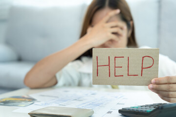 Stressed and headache woman hold help with large bills or invoices, No money to pay to expenses and credit card debt. shortage, Financial problems, mortgage, loan, bankruptcy, bankrupt, poor