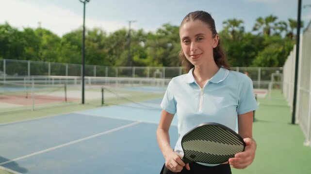 Confident and healthy women stand on a pickleball field, practicing or playing pickleball, an outdoor activity enjoyed with friends, improving their athletic abilities, healthy lifestyle combined.