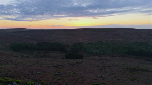 A low drone flight over Higger Tor towards the Burbage Valley at sunrise.