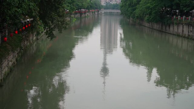 Jinjiang river in city Chengdu, travel in China, reflection of city view in water . Tourist trip to Asia, unity of nature and modern architecture, contemplation and relaxation in metropolis, urbanism