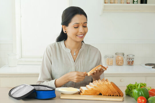 Woman buttering bread