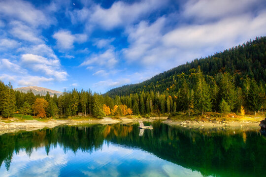 Paradise beach in bay of Cauma Lake (Caumasee) with crystal blue water in beautiful mountain landscape scenery at Flims, Graubuenden - Switzerland