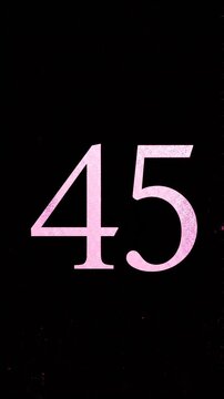 Pink Glitter Blow‑Away Reveal of Number 45 on Solid Background
