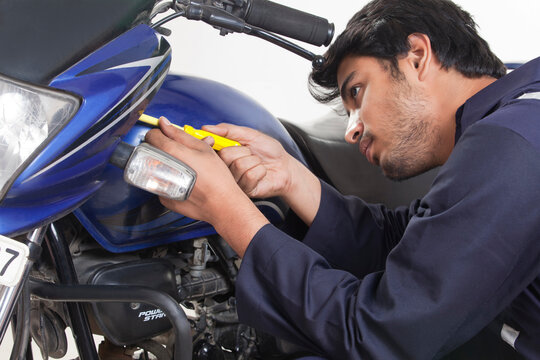 Mechanic working on motorcycle