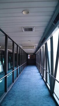 Long Empty Corridor Inside Airport Passenger Boarding Bridge Tunnel