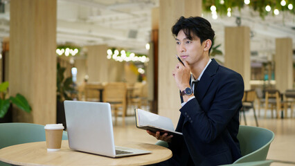 Fototapeta premium businessman company manager investor working on computer technology sitting at co working office desk. Busy professional businessman executive using laptop at work writing notes.