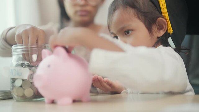 Young Girl Learning Money Saving Skills with Mother's Guidance and Piggy Bank