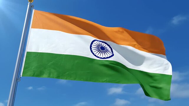 Vibrant Indian Flag Waving in Sunny Blue Sky - A vibrant Indian flag flutters majestically against a bright blue sky on a clear sunny day.