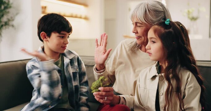 Grandma, children and high five with frog toy in home for fun fact, weekend or bonding together. Grandmother, talking and kids with smile or animal for learning, education or development in house