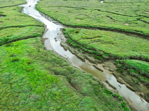 Dramatic aerial view of salt water marshes which are used as a flood plain as seen on the north Norfolk, UK coast. Deep mud and tidal forces make this area dangerous.