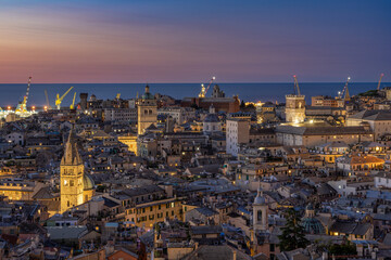 Fototapeta premium Genova, Italy city skyline view towards the historic belvedere castelletto at twilight.