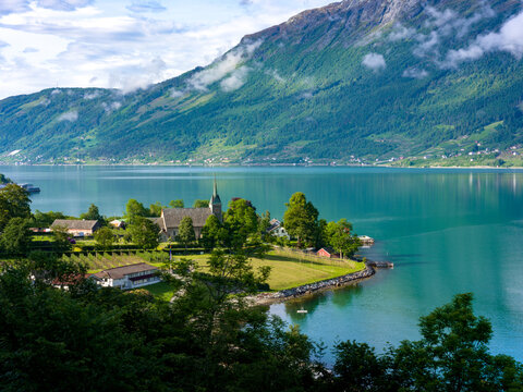 Mountain landscape and the white wooden Oppstryn Church in Stryn Municipality in Sogn og Fjordane county, Norway.
