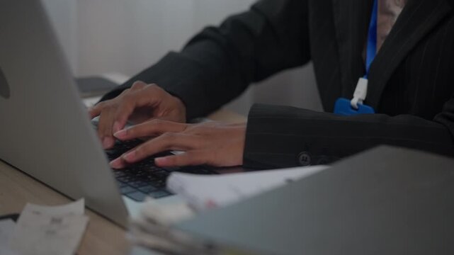 Close Up of Hands Typing on Laptop Keyboard for Business Administration and Office Productivity