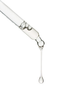 Dropper with a clear drop of cosmetic serum or gel falling, isolated on transparent background. PNG Image.