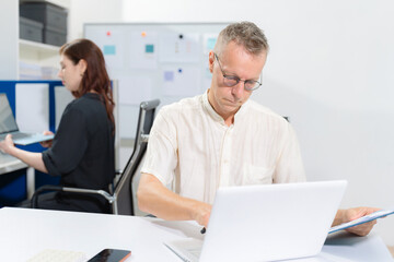 Fototapeta premium Diverse professionals collaborate on project analysis with financial graphs. Strategic teamwork and insights drive company growth and success.