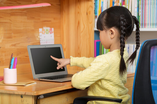 cheerful Asian girl using laptop for online class at home, distance learning and e-education concept.