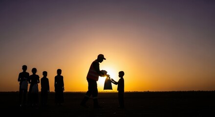 Fototapeta premium Humanitarian aid worker gives supplies to children at sunset
