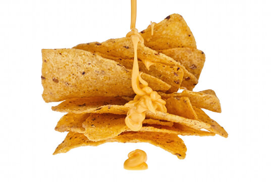 Golden Corn Tortilla Chips with Pouring Creamy Cheese Sauce