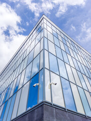 Obraz premium Glass building exterior with security cameras outside
