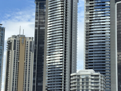 Modern Glass Skyscrapers and Luxury Apartment Towers Under Blue Sky