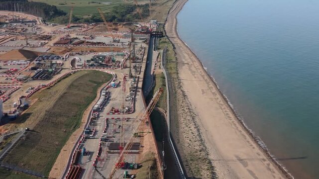 Drone Dolly In Over Sizewell Nuclear Power Station Construction Site and Suffolk Coast England