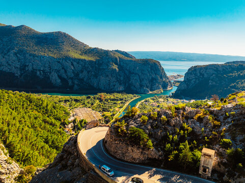 Aerial view of Omis city and the Cetina river canyon meeting the Adriatic sea, featuring historic Mirabella fortress and mountains, Dalmatia, Croatia