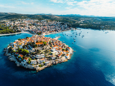 Aerial view of the historic town of Primosten on a peninsula, surrounded by crystal clear turquoise Adriatic sea, Dalmatia, Croatia.