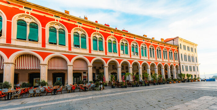 The iconic Republic Square (Prokurative) in Split, stunning red neo-Renaissance architecture and grand arches, Dalmatia, Croatia.