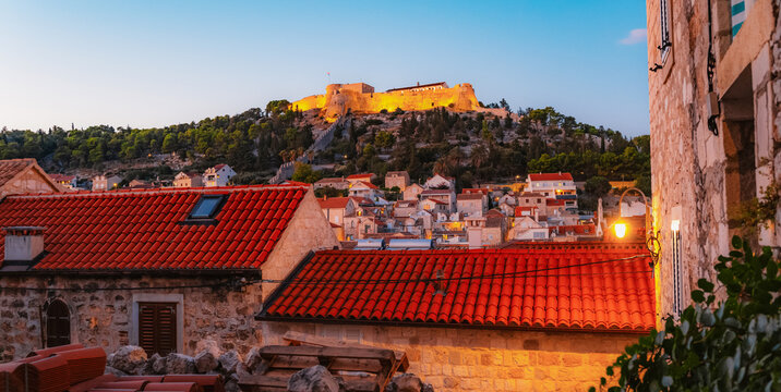 The grand St. Stephen's Square in Hvar town,  the Cathedral, the historic Arsenal, and elegant Venetian-style stone architecture, Croatia.