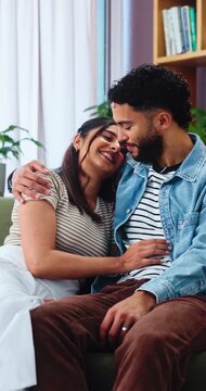 Kiss, couple and love on sofa with smile, bonding and gossip in living room. Embrace, happy man and woman with communication in house for relationship, relax or weekend in home lounge with support
