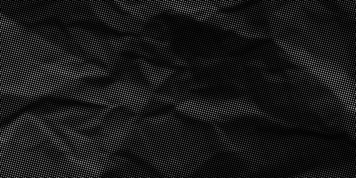 Halftone crumpled paper texture with black dots. Black creased sheet background. Rough and wrinkled surface. Grunge retro newspaper background with grainy effect. Vector illustration