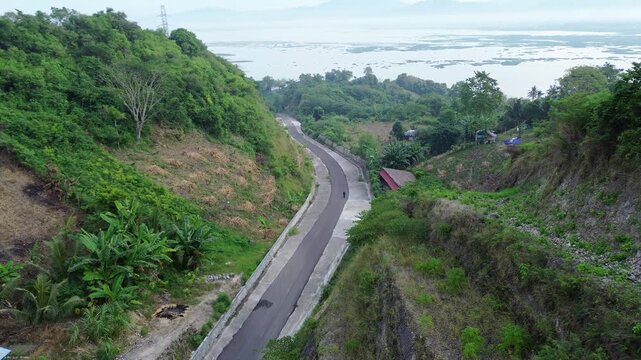 Aerial View of Winding Road Near Lake
