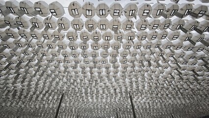 Hundreds of white paper lanterns arranged in symmetrical rows at a Buddhist temple, creating a striking geometric pattern in South Korea. © Carla
