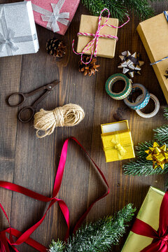 new year party preparation with gifts wrapping in boxes on wooden background top veiw