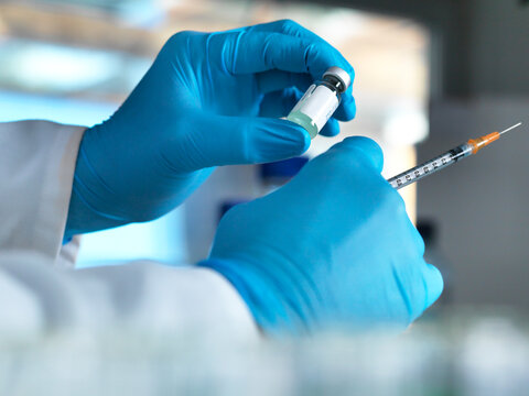 Doctor preparing a vaccine for an injection