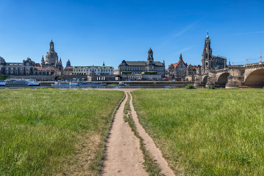 Footpath through a meadow towards the historic skyline of Dresden