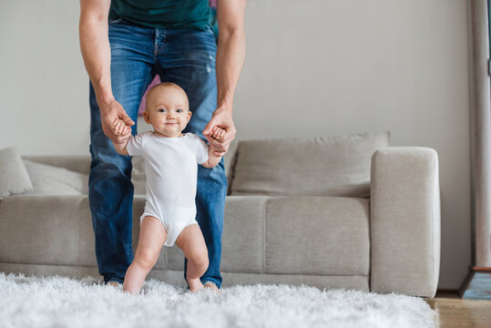 Father with baby girl at home in living room
