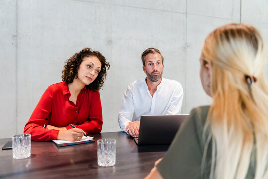 Businesswoman taking job interview of candidate in board room