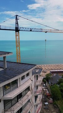 Aerial View of Beachfront Building Construction and Tower Crane