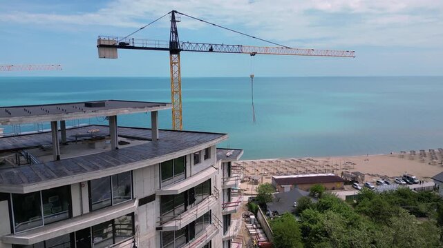 Aerial View of Beachfront Building Construction and Tower Crane